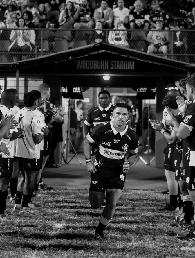 Hollywoodbets Sharks XV players run out onto the field in front of supporters at Woodburn Stadium.