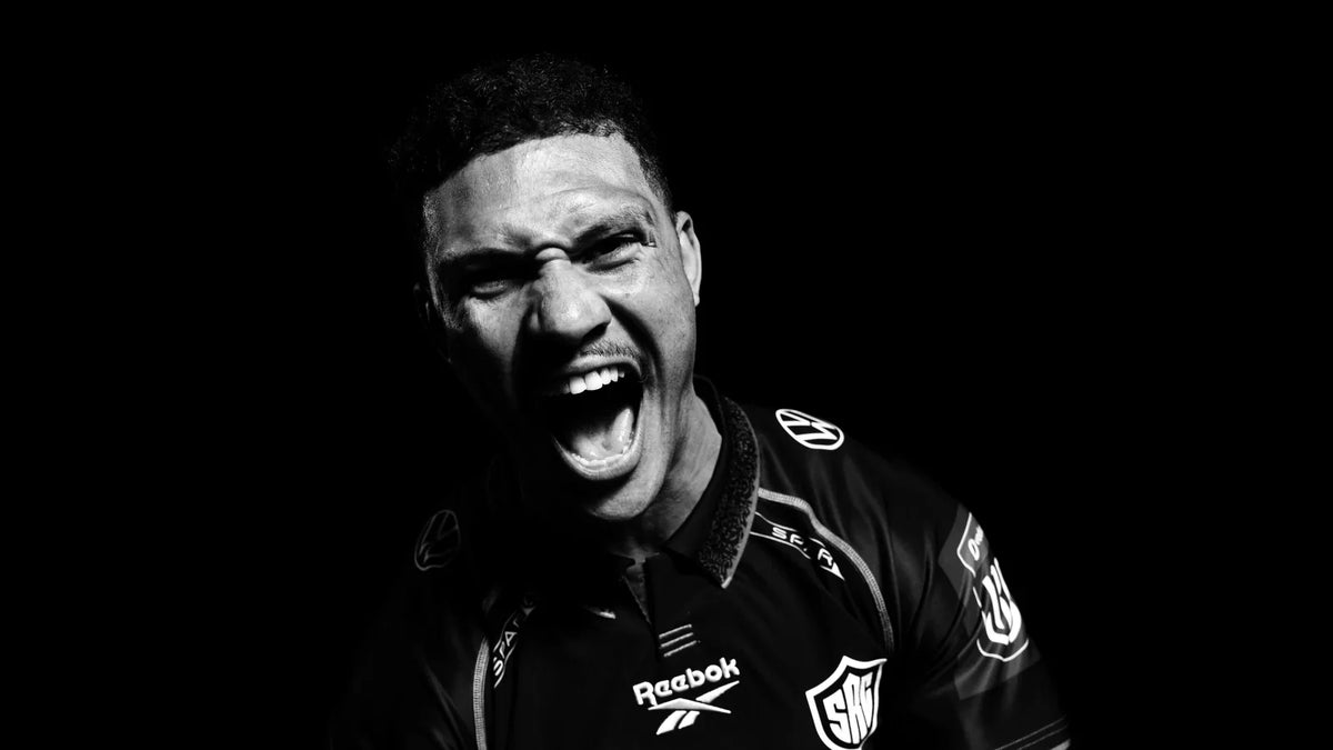 Hollywoodbets Sharks wing Edwill van der Merwe roars at the camera in a black-and-white studio portrait, wearing the Sharks jersey against a black background.