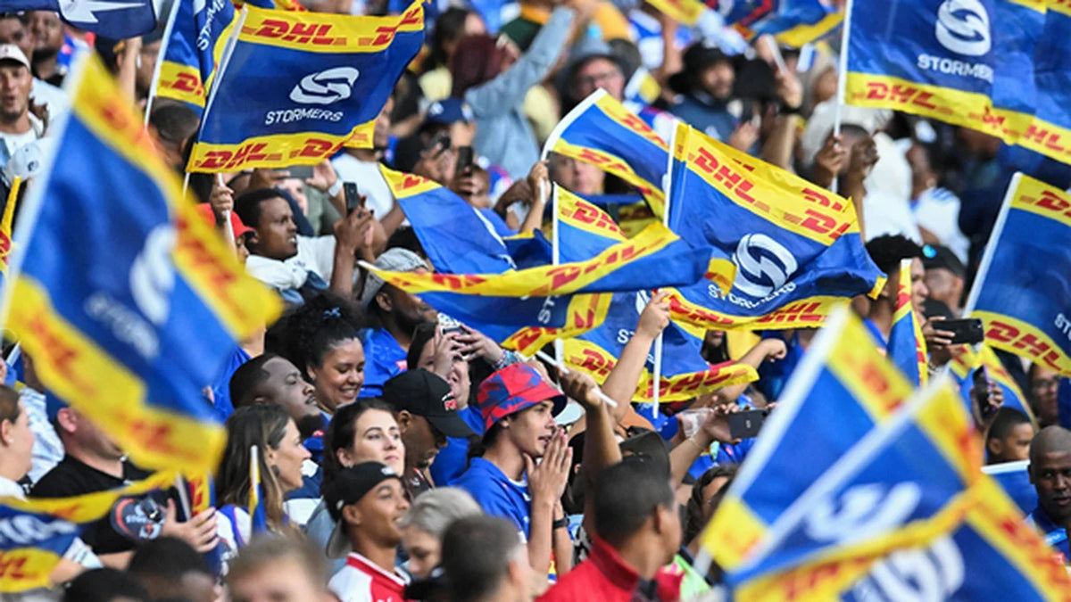 DHL Stormers supporters packed into the stand at DHL Stadium, waving a sea of blue and yellow Stormers flags.