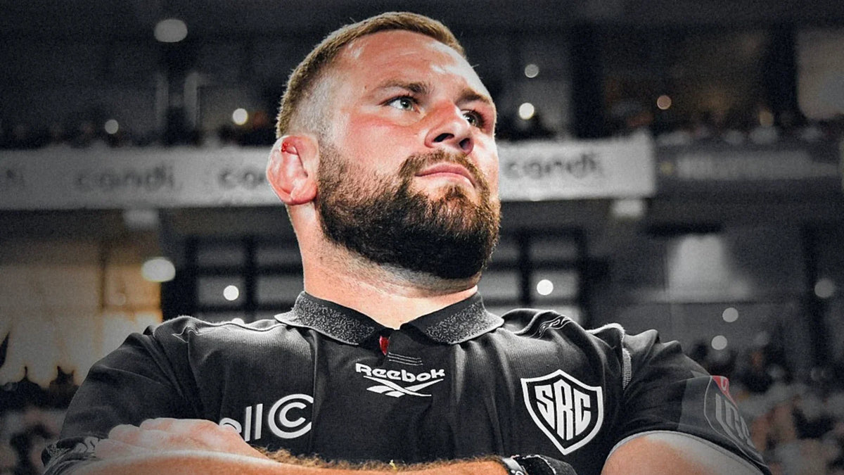 Sharks prop Thomas du Toit stands with arms folded in the black Sharks jersey, looking up into a packed stadium.